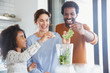 © Sam Edwards/Caia Image - Multi-ethnic family making healthy green smoothie in blender in kitchen