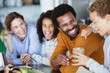 © Sam Edwards/Caia Image - Laughing family drinking healthy green smoothie in kitchen