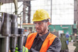 © Lukasz Olek/Caia Image - Focused male worker examining steel parts in factory