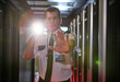 © Agnieszka Olek/Caia Image - Portrait male security guard flashlight gesturing stop in server room