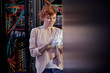 © Agnieszka Olek/Caia Image - Female IT technician using futuristic digital tablet in server room