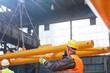 © Lukasz Olek/Caia Image - Male worker walkie-talkie guiding lowering of equipment in factory