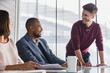 © Caiaimage/Martin Barraud/Caia Image - Smiling businessman leading conference room meeting