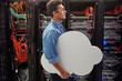 © Agnieszka Olek/Caia Image - Male IT technician carrying cloud in server room, cloud computing