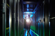 © Agnieszka Olek/Caia Image - Male security guard with flashlight walking in dark server room