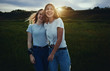 © Arman Zhenikeyev/Caia Image - Portrait smiling, happy teenage sisters in rural field