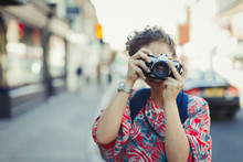 Portrait Young Woman Photographing With Camera On Street