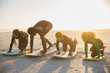 © Sam Edwards/Caia Image - Father surfer teaching children surfing on surfboard on sunny summer beach
