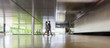 © Caiaimage/Martin Barraud/Caia Image - Businessman and businesswoman walking in modern office lobby