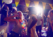 © Trevor Adeline/Caia Image - Young friends with party favors dancing and hanging out at party