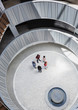 © Caiaimage/Martin Barraud/Caia Image - View from above business people talking in round, modern office atrium courtyard