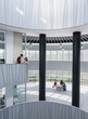 © Caiaimage/Martin Barraud/Caia Image - Business people meeting on architectural, modern office atrium balcony