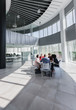 © Caiaimage/Martin Barraud/Caia Image - Business people meeting at table in modern office atrium