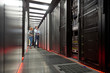 © Agnieszka Olek/Caia Image - IT technicians talking at panel in server room