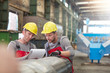 © Agnieszka Olek/Caia Image - Male workers with clipboard in factory