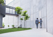 © Martin Barraud/Caia Image - Supervisors walking on sidewalk below building