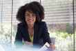 © Caiaimage/Sam Edwards/Caia Image - Portrait smiling, confident businesswoman reviewing paperwork