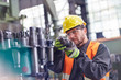 © Rafal Rodzoch/Caia Image - Male worker examining steel parts in factory