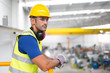 © Sam Edwards/Caia Image - Serious male supervisors leaning on platform railing in factory