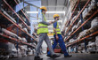 © Martin Barraud/Caia Image - Workers with clipboard walking in warehouse