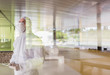 © Caiaimage/Martin Barraud/Caia Image - Scientist in clean suit using digital tablet at window