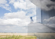 © Caiaimage/Martin Barraud/Caia Image - Pensive businessman on modern landing looking out window at sunny blue sky clouds