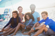 © Sam Edwards/Caia Image - Portrait smiling multi-ethnic family on sunny summer beach