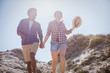 © Sam Edwards/Caia Image - Multi-ethnic couple walking, holding hands on sunny summer beach path