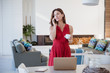 © Sam Edwards/Caia Image - Brunette businesswoman drinking coffee, working at laptop in dining room