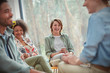 © Caiaimage/Agnieszka Olek/Caia Image - People smiling and laughing in group therapy session