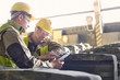 © Caiaimage/Agnieszka Olek/Caia Image - Steelworkers using digital tablet in steel mill