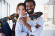 © Sam Edwards/Caia Image - Portrait smiling, confident multi-ethnic couple hugging