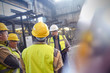© Caiaimage/Agnieszka Olek/Caia Image - Supervisor and steelworkers talking in meeting in steel mill