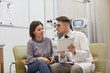 © Seventyfour - Portrait of young ophthalmologist using digital tablet while consulting female patient during eyesight check up in modern clinic, copy space