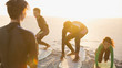 © Sam Edwards/Caia Image - Father surfer teaching children surfing on surfboards on sunny summer beach