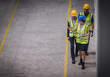 © Martin Barraud/Caia Image - Female supervisor and male workers walking and talking in factory