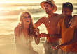 © Trevor Adeline/Caia Image - Laughing young friends on sunny summer beach