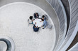© Caiaimage/Martin Barraud/Caia Image - View from above architects meeting in atrium courtyard