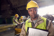 © Caiaimage/Agnieszka Olek/Caia Image - Portrait serious, confident steelworker with clipboard in steel mill