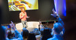 © Tom Merton/Caia Image - Speaker on stage answering audience questions