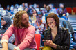 © Tom Merton/Caia Image - Man and woman with with smart phone in conference audience