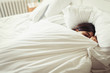 © Caiaimage/Paul Bradbury/Caia Image - Tired young woman sleeping in bed