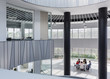 © Caiaimage/Martin Barraud/Caia Image - Business people meeting at table in architectural, modern office atrium