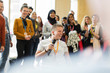 © Martin Barraud/Caia Image - Conference audience clapping for smiling female speaker microphone