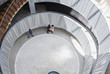 © Caiaimage/Martin Barraud/Caia Image - View from above business people talking in architectural, modern office atrium courtyard