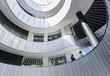 © Caiaimage/Martin Barraud/Caia Image - Businessmen talking on architectural, modern office atrium balcony