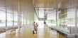 © Caiaimage/Martin Barraud/Caia Image - Scientists in lab coats talking in modern office lobby corridor