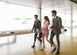 © Caiaimage/Martin Barraud/Caia Image - Business people walking and talking in office corridor