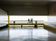 © Caiaimage/Martin Barraud/Caia Image - Business people walking along elevated walkway in modern office lobby