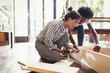© Caiaimage/Paul Bradbury/Caia Image - Young women assembling furniture with power drill